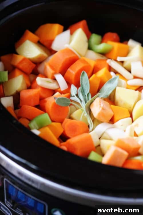 Slow Cooker Root Vegetable Stew | Gimme Some Oven Close-up of a serving of Slow Cooker Root Vegetable Stew, garnished with fresh herbs