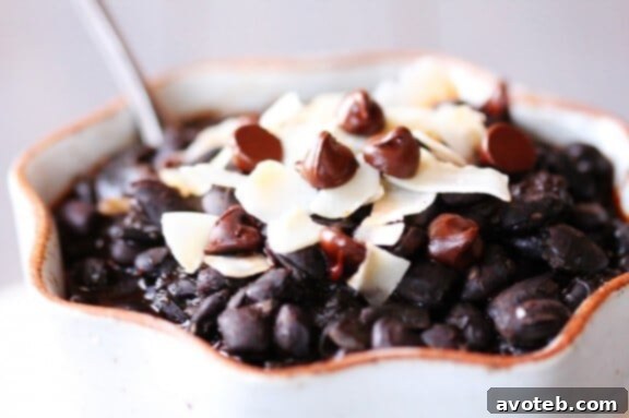 Black Bean Chili with Chocolate and Coconut served in a rustic bowl with toppings
