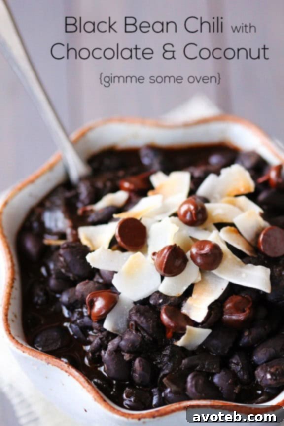 Close-up of Black Bean Chili with Chocolate and Coconut, showing its rich texture and toppings