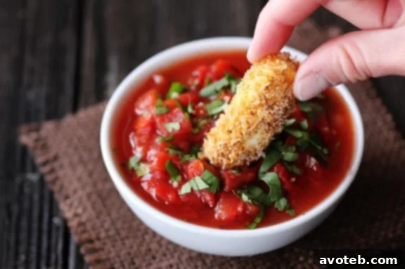 Delicious Baked Mexican Mozzarella Cheese Sticks served with fresh salsa, a healthier twist on a classic appetizer.
