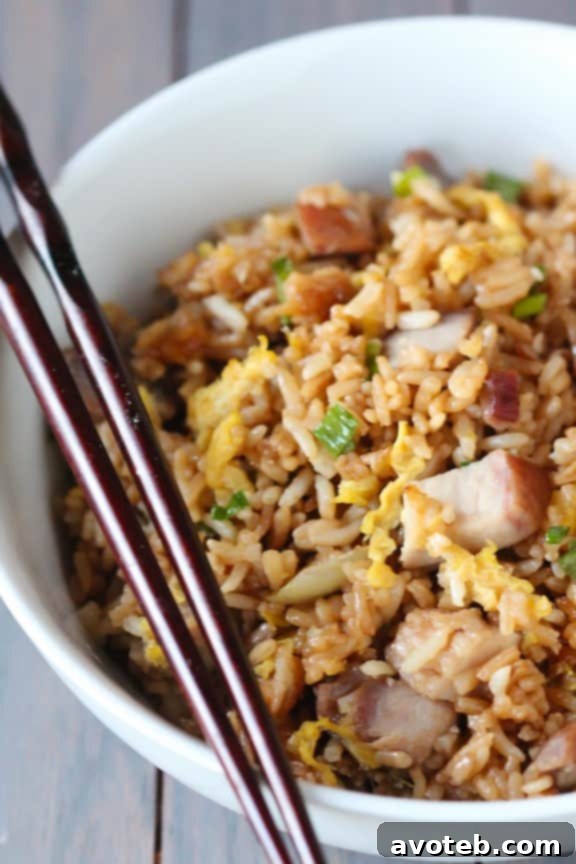 A serving of freshly prepared Pork Fried Rice in a bowl, ready to be enjoyed as a main course or side dish.