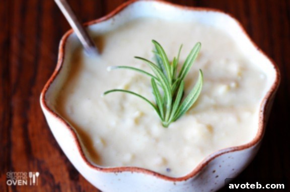 Creamy Potato Pear Soup Garnished with Fresh Rosemary