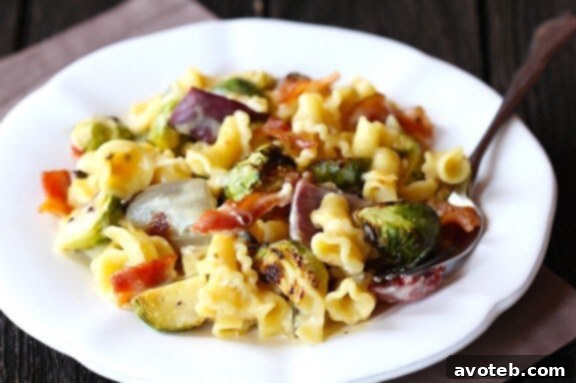 Brussel Sprouts, Bacon & Pepperjack Macaroni & Cheese | gimmesomeoven.com A close-up image of a delicious dish of Brussels Sprouts, Bacon & Pepperjack Macaroni & Cheese, emphasizing the rich textures and appetizing appeal.
