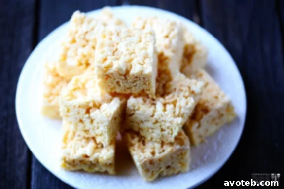 Delicious Coconut Oil Rice Krispie Treats, perfectly cut and ready to serve on a white plate