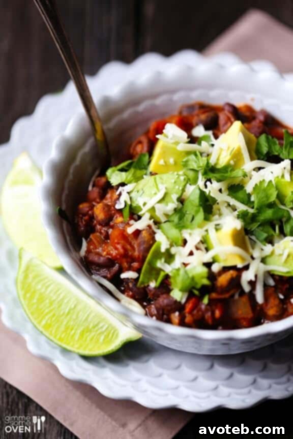 Delicious Smoky Black Bean Chili served in a bowl with fresh toppings, showcasing its rich texture and vibrant colors.