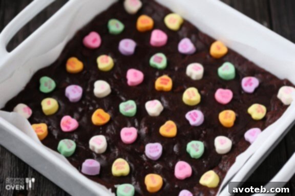 Love Note Brownies 3 Close-up of a square conversation heart brownie, showcasing its fudgy texture and colorful candy topping