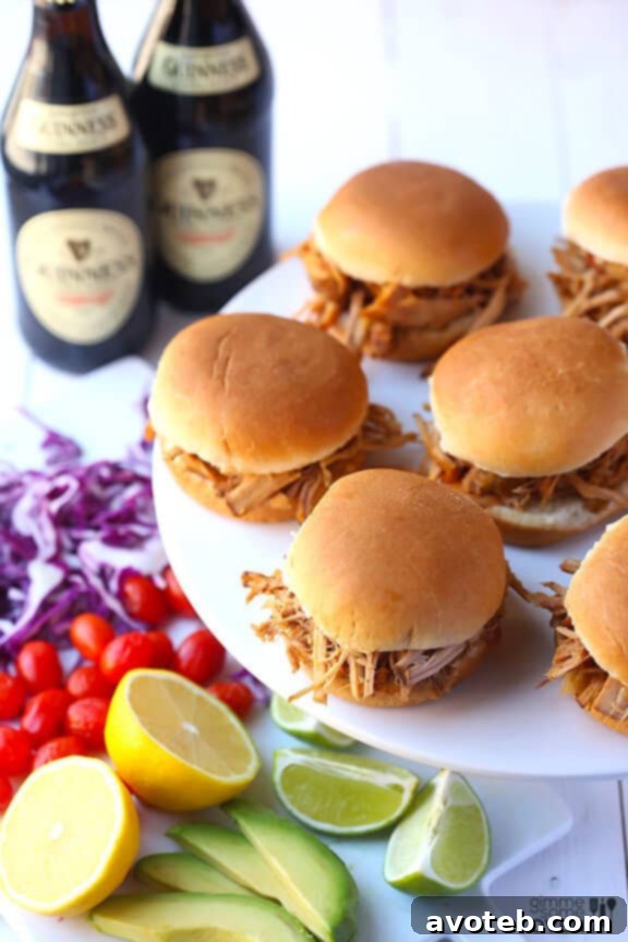 Guinness Pulled Pork cooking in a slow cooker, surrounded by onions and Guinness stout