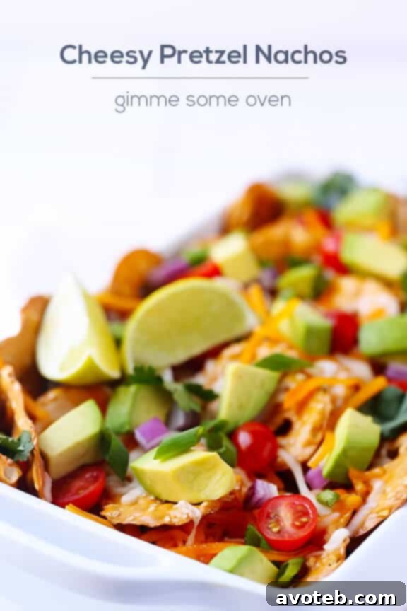 Closeup of Loaded Cheesy Pretzel Nachos with melted cheese and fresh toppings