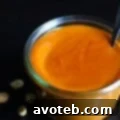 Homemade Thai Peanut Sauce in a bowl with ingredients around it.