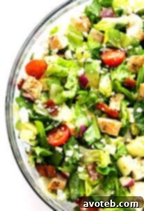 A vibrant close-up of the Chicken, Bacon, and Avocado Chopped Salad.