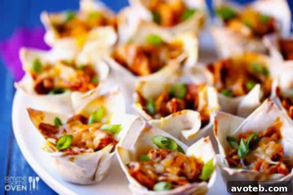 Mini Chicken Enchilada Bites 2 Easy Chicken Enchilada Cups: A vibrant appetizer with shredded chicken, cheese, and homemade enchilada sauce baked in crispy wonton cups.