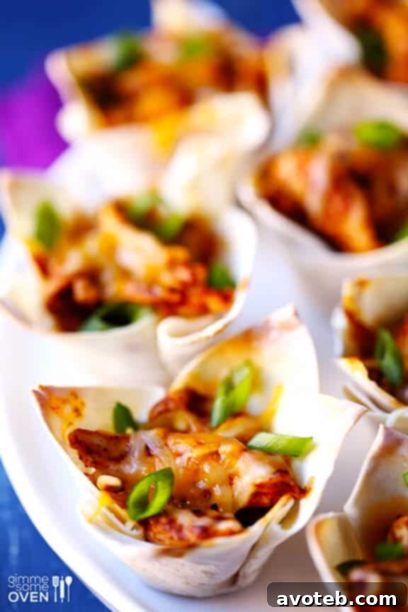 Mini Chicken Enchilada Bites 3 Chicken Enchilada Cups: Perfectly baked, golden-brown wonton wrappers filled with seasoned chicken and melted cheese.
