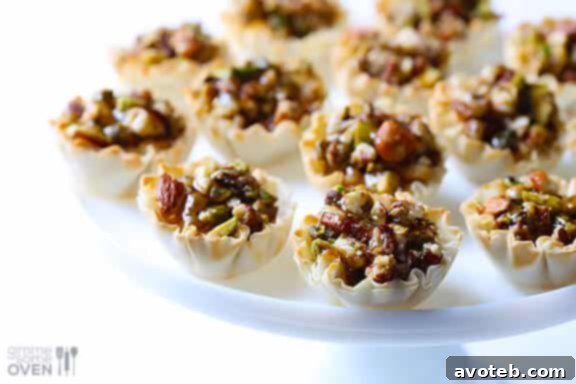 A hand holding a single Baklava Cup