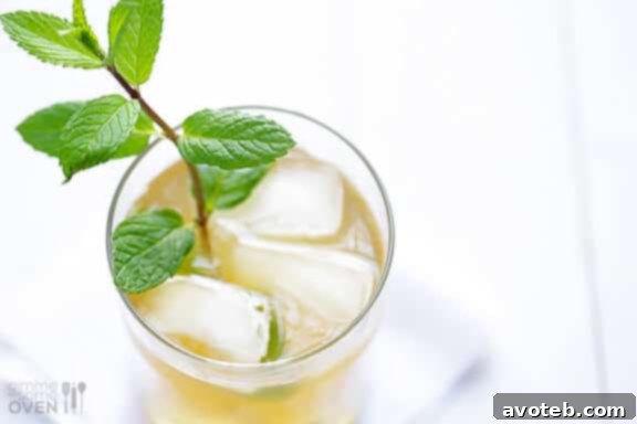 Table setting with sparkling ginger mint juleps and a hint of party decorations.