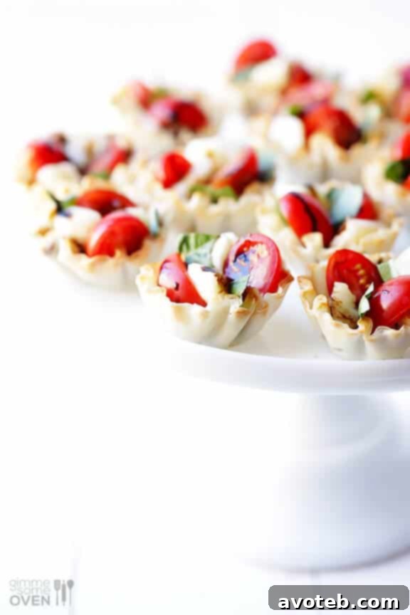 Hands holding a Caprese Phyllo Cup