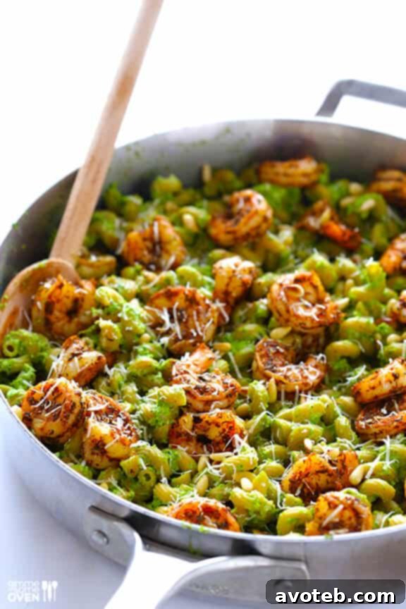 Large serving of asparagus-spinach pesto pasta with blackened shrimp.