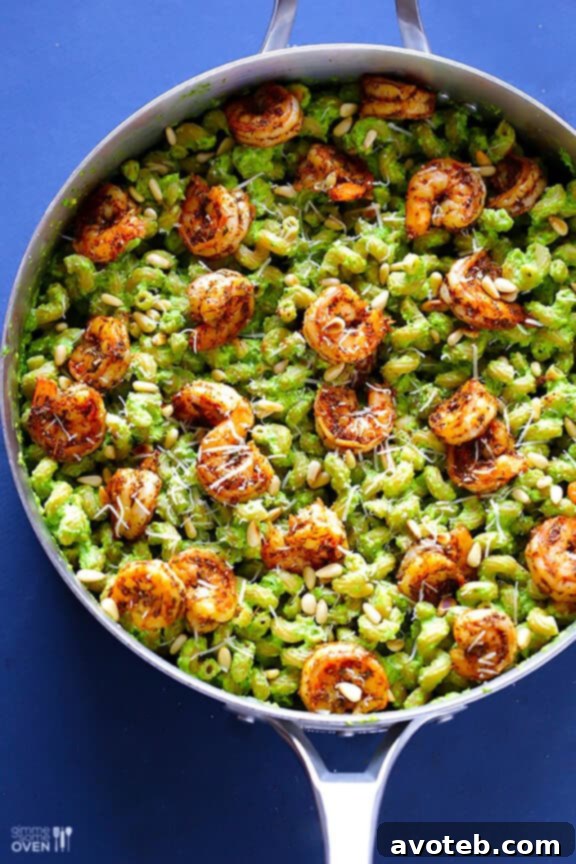 Close-up of asparagus-spinach pesto pasta with a fork.