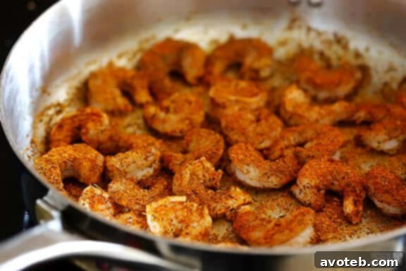 Raw shrimp coated in blackening seasoning.