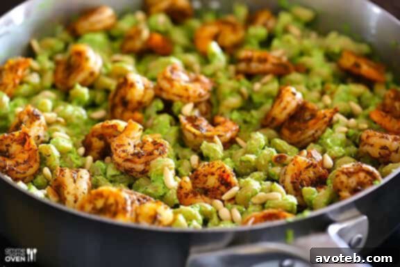 Pesto being tossed with pasta.