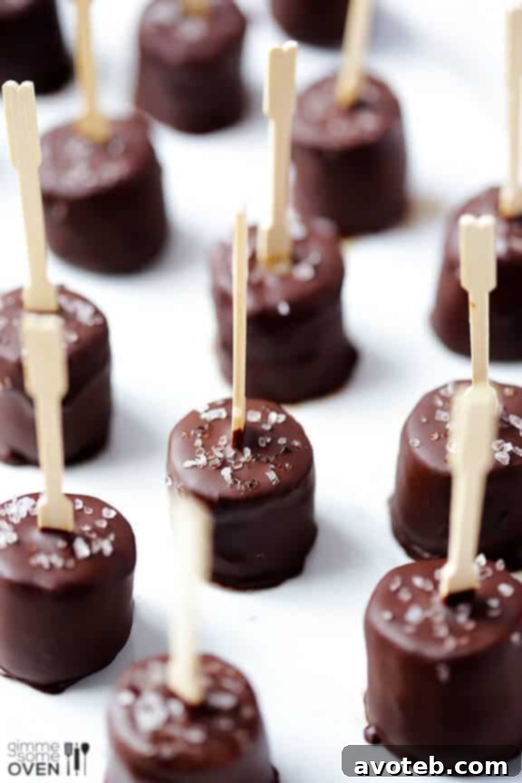Many Salted Chocolate Frozen Banana Bites arranged on a platter with sea salt flakes