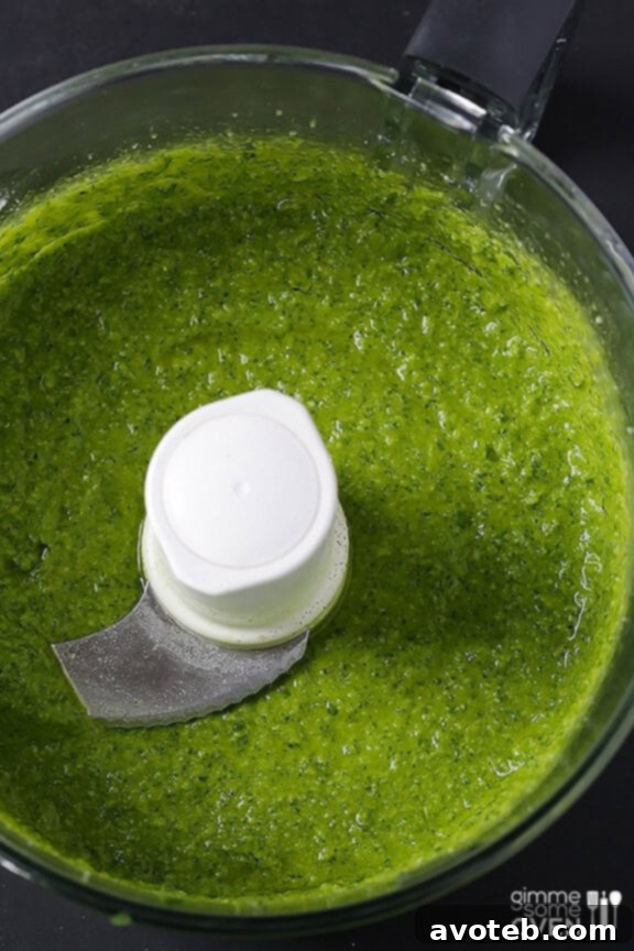A serving of Arugula Pesto Pasta on a plate, ready to be enjoyed.