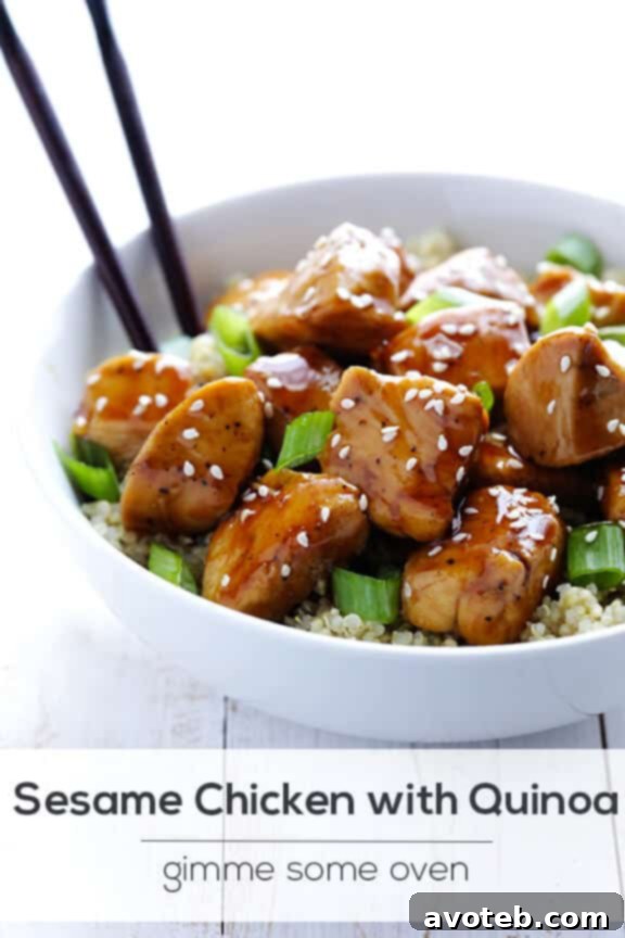 Artfully plated lighter sesame chicken with quinoa, garnished with green onions and sesame seeds. Highlighting the healthy and appealing nature of the dish, ready to be enjoyed.
