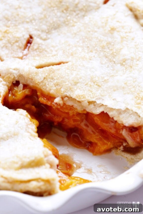 Juicy Peach Bourbon Pie filling bubbling through the crust