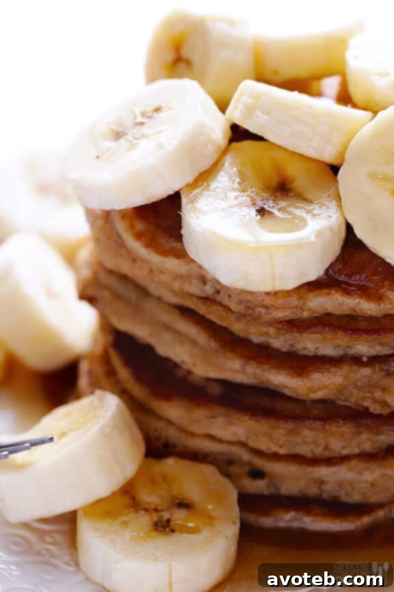 Close-up of golden banana pancakes with melted butter
