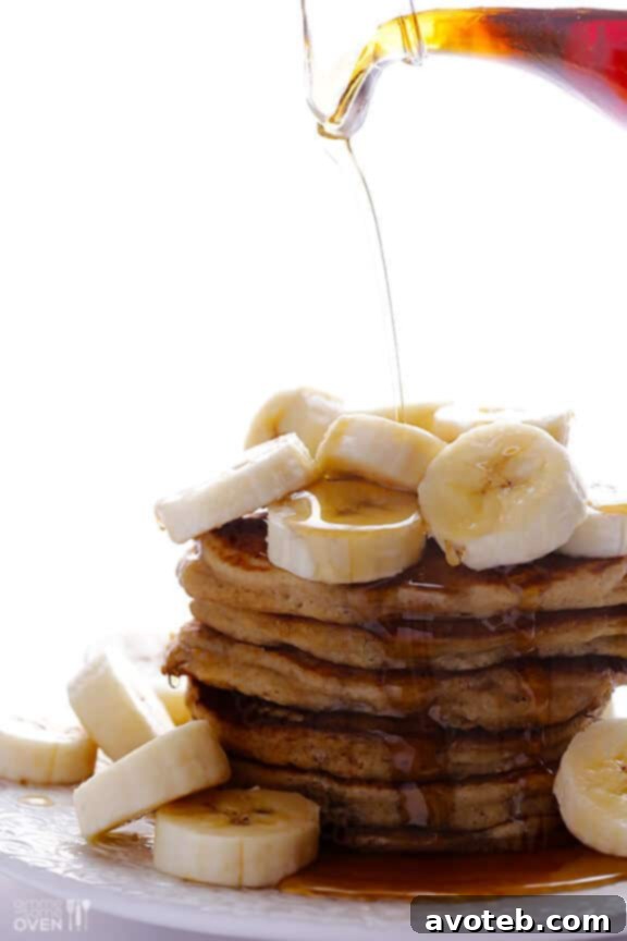 Delicious banana pancakes with a pool of maple syrup