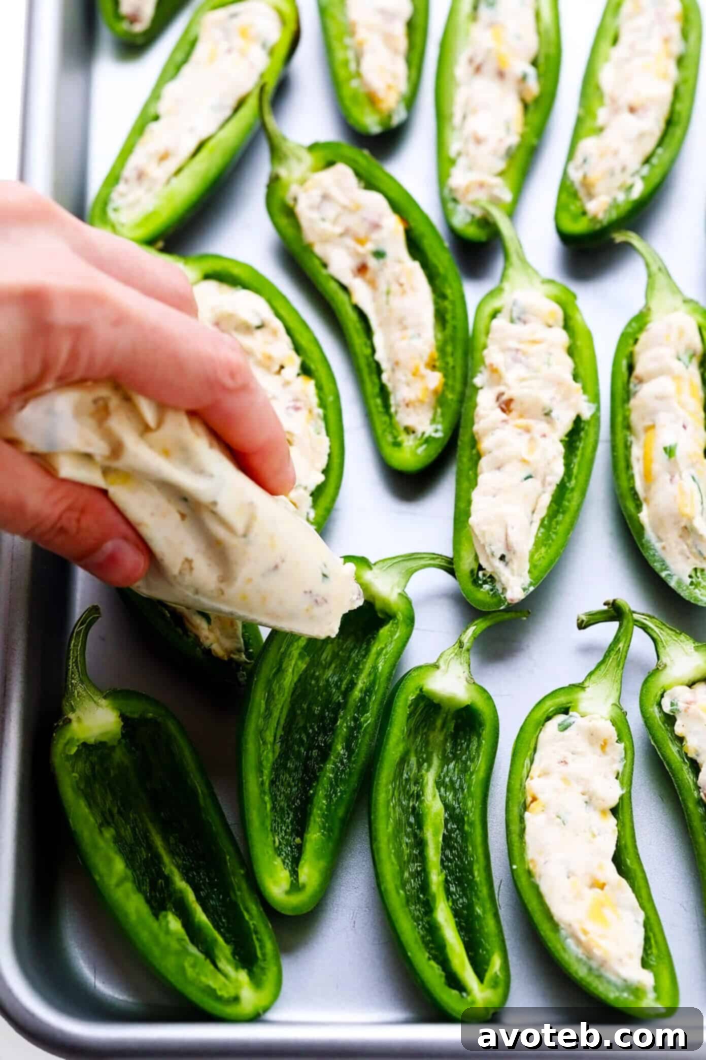 Fresh jalapeno peppers halved and cored, ready for filling