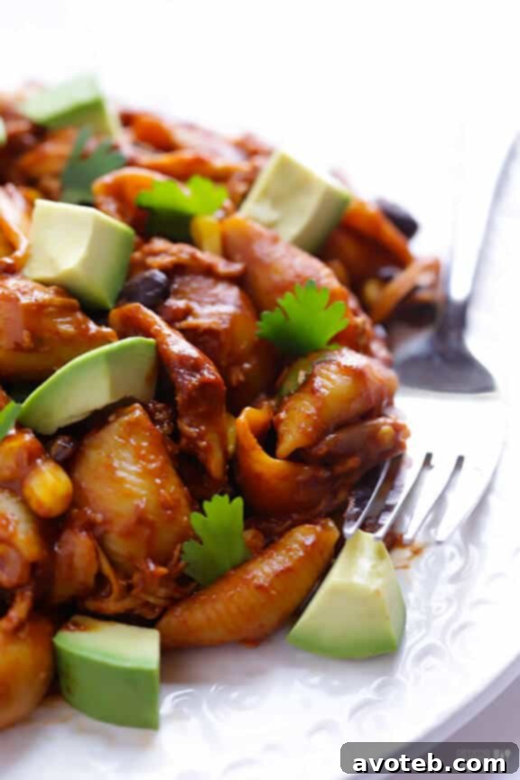 Close-up of bubbling Chicken Enchilada Pasta Bake topped with cilantro