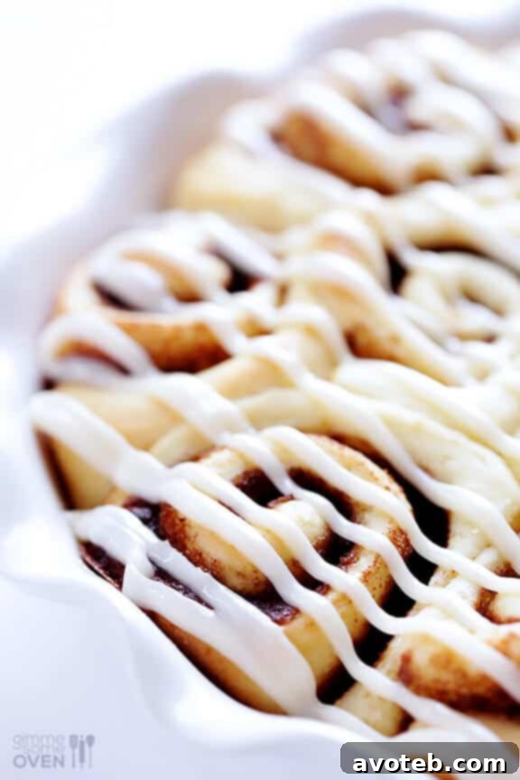 Plate of classic 1-Hour Easy Cinnamon Rolls with white frosting.