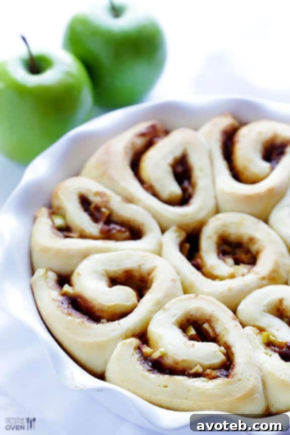 The dough tightly rolled into a log, ready for slicing into individual cinnamon rolls.