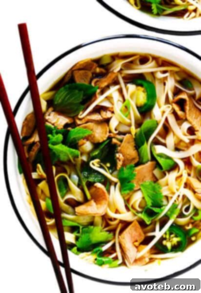 A steaming bowl of Vietnamese Pho soup, ready to be enjoyed.