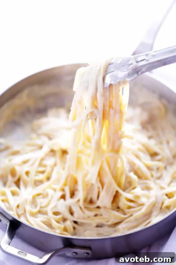 Draining pasta and adding to Alfredo sauce