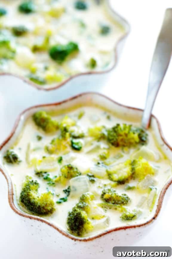 A serving of creamy 5-Ingredient Broccoli Cheese Soup, garnished with a sprinkle of fresh black pepper, highlighting its comforting and easy-to-make appeal.