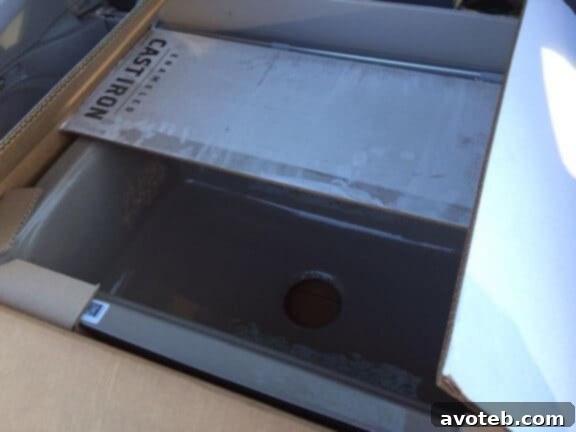 Kohler cast iron sink packaged in its box, awaiting installation in the new kitchen.