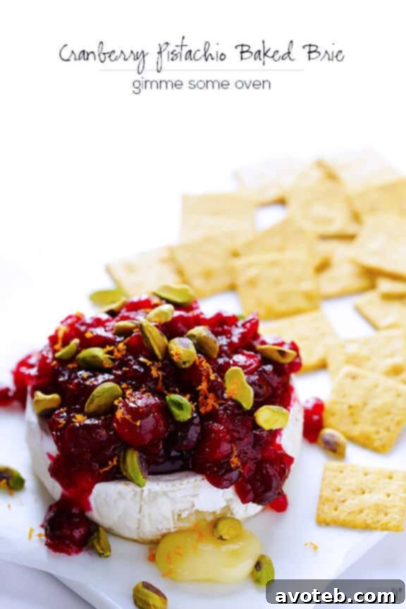 Cranberry Pistachio Baked Brie Recipe Cranberry Pistachio Baked Brie served on a board with crackers, ready to be enjoyed.
