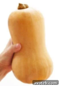 Close-up of freshly diced butternut squash on a cutting board, neatly prepared and ready for cooking in various delicious recipes.
