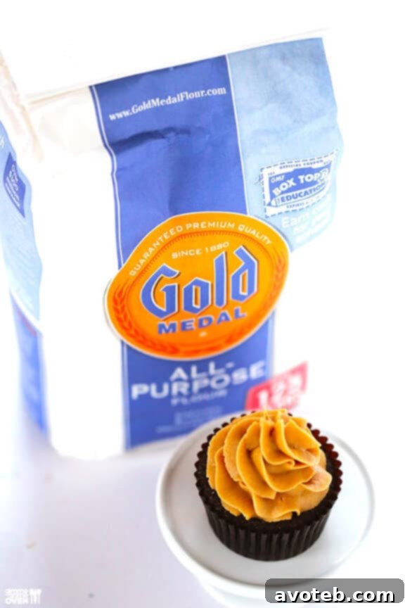 Decadent Chocolate Peanut Butter Cupcakes 3 A batch of freshly baked and frosted Chocolate Peanut Butter Cupcakes on a wire rack.