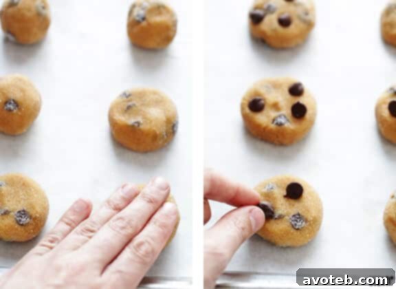 Flattening cookie dough balls with a fork before baking