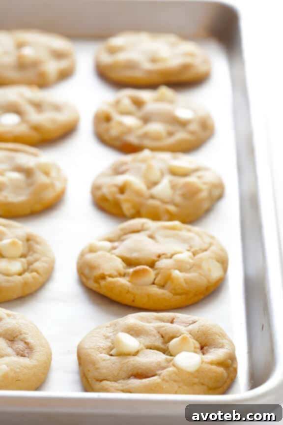 Bake Your Own Caramel White Chocolate Cookies Homemade Caramel White Chocolate Cookies cooling on a wire rack, ready for caramel drizzle.