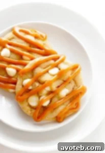 A delectable Caramel White Chocolate Cookie with a rich caramel drizzle.