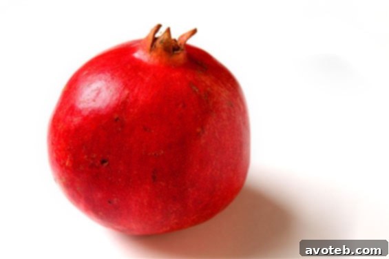 A step-by-step tutorial image showing how to open and de-seed a pomegranate efficiently, demonstrating the process clearly.
