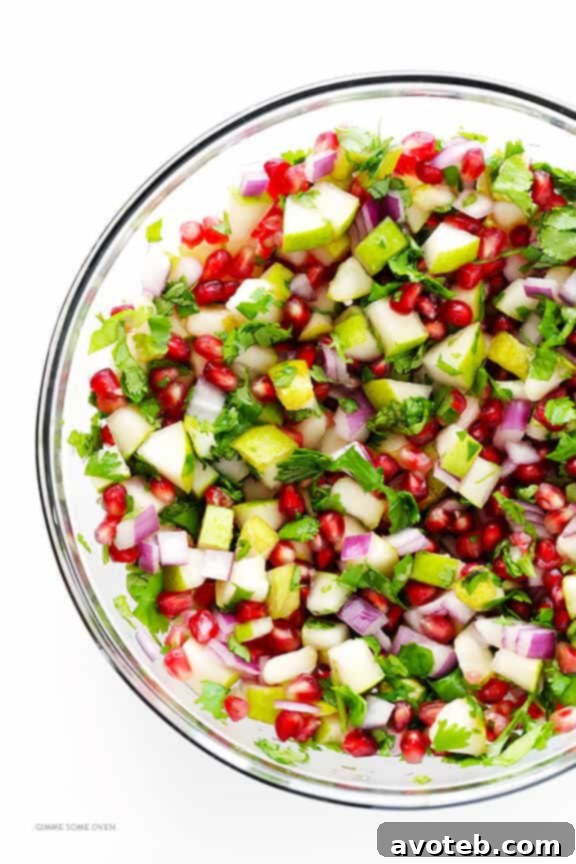A bowl of freshly made Pear Pomegranate Salsa, perfectly seasoned and ready to be served, highlighting its exquisite texture and visual appeal.