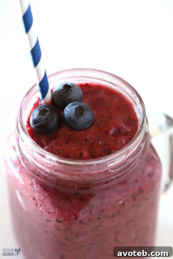 Close-up of a fresh, healthy Blueberry Avocado Smoothie being poured into a glass, highlighting its smooth consistency.