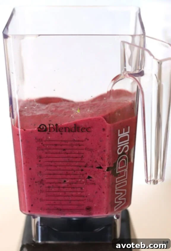 Blender in action, mixing the Blueberry Avocado Smoothie ingredients into a smooth consistency.