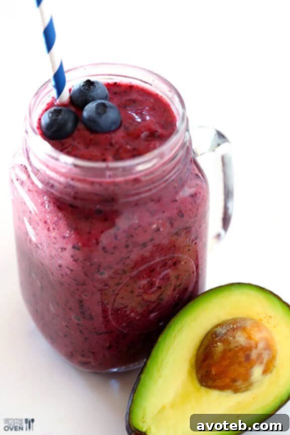 A freshly blended Brain Power Smoothie in a glass, topped with a few blueberries, ready to drink and enjoy its brain-boosting benefits.