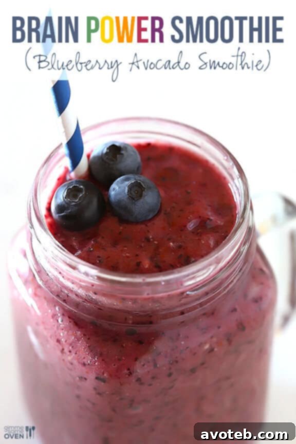 Another appealing shot of the Brain Power Smoothie in a glass, with fresh fruit in the background, emphasizing its natural goodness.