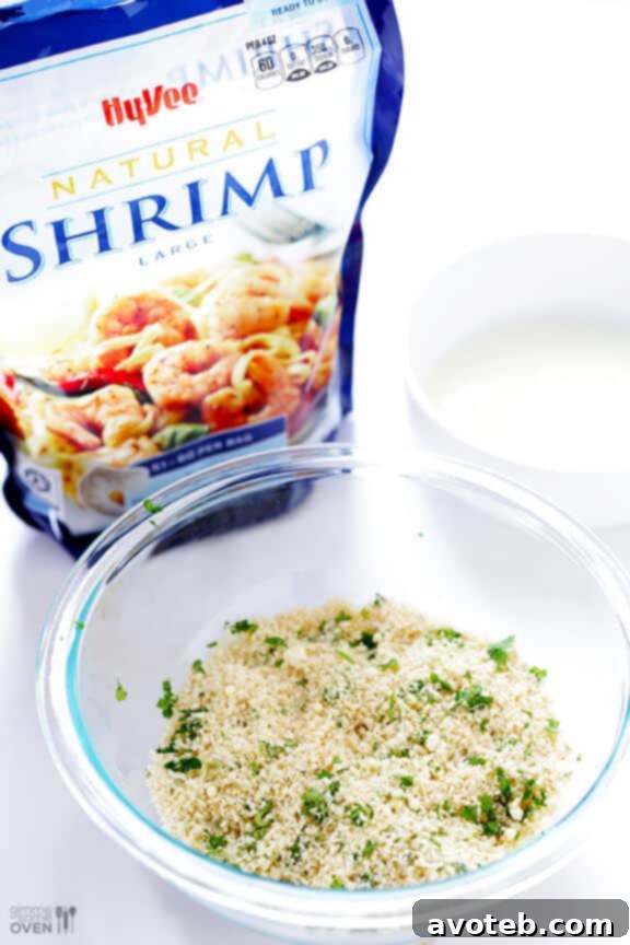 The secret to crispy baked popcorn shrimp: a generous coating of seasoned Panko breadcrumbs after dipping in egg white.